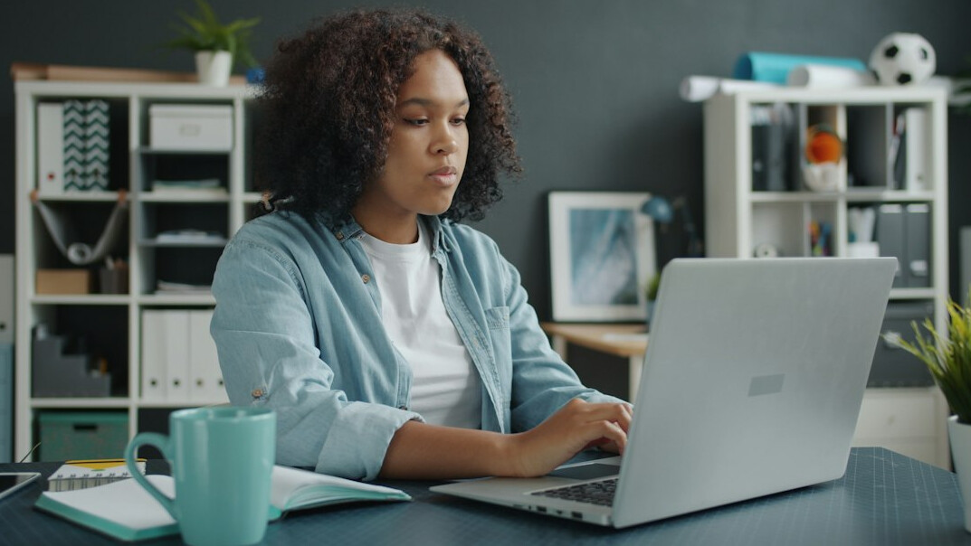 woman coding at home desk