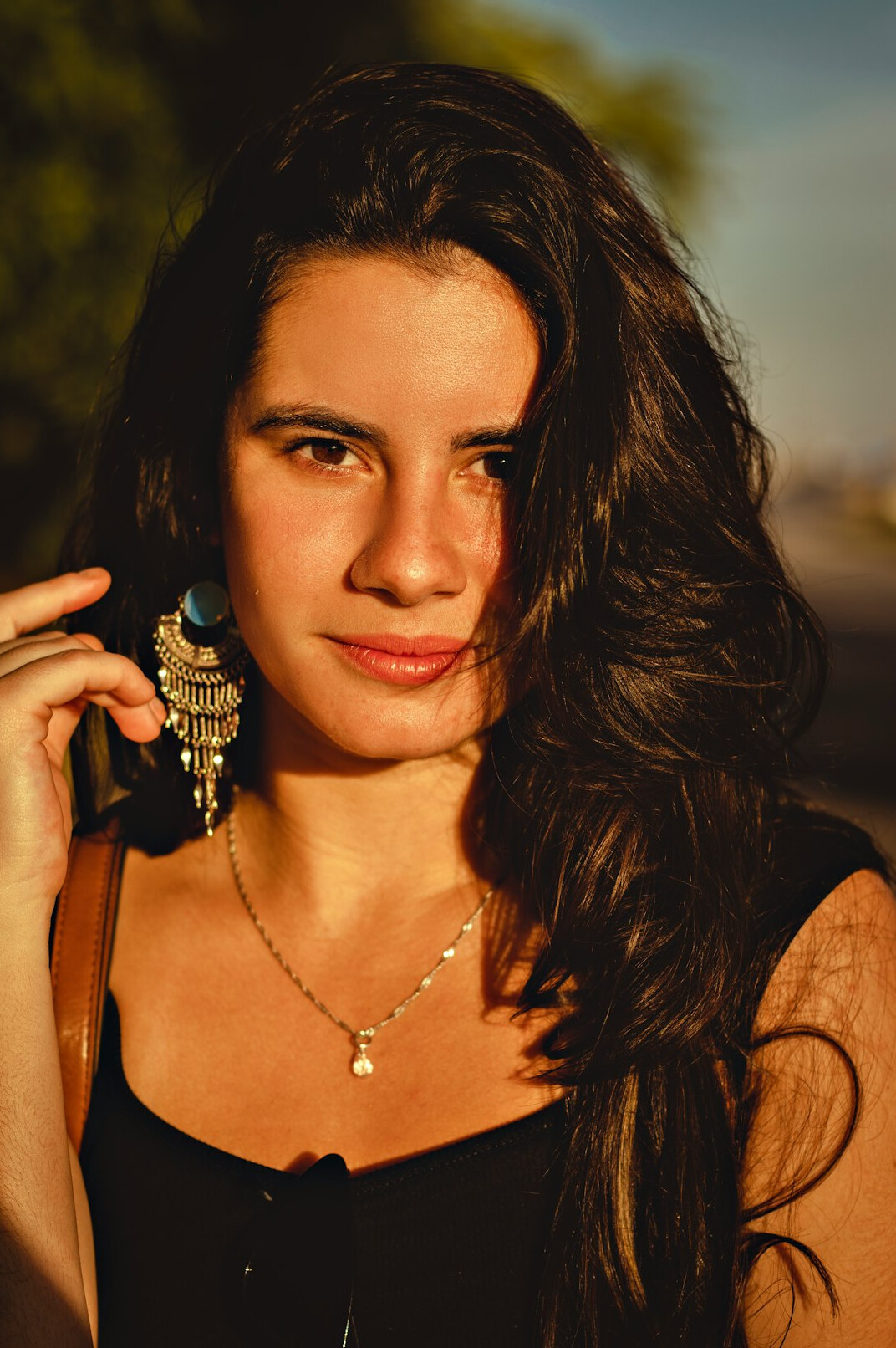 Portrait of a young woman with long dark hair smiling
