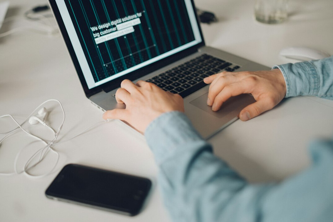 developer writing code on laptop